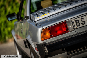 Fiat X1 9 Storia – rear three-quarter, silver against a leafy green backdrop