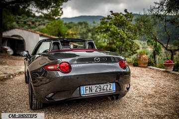 Mazda MX 5 Cherry Edition – rear three-quarter, dark grey metallic on a gravel driveway