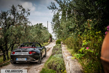 Mazda MX 5 Cherry Edition – rear three-quarter, dark grey metallic on a narrow country road