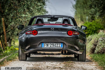 Mazda MX 5 Cherry Edition – rear view, dark grey on a dirt road