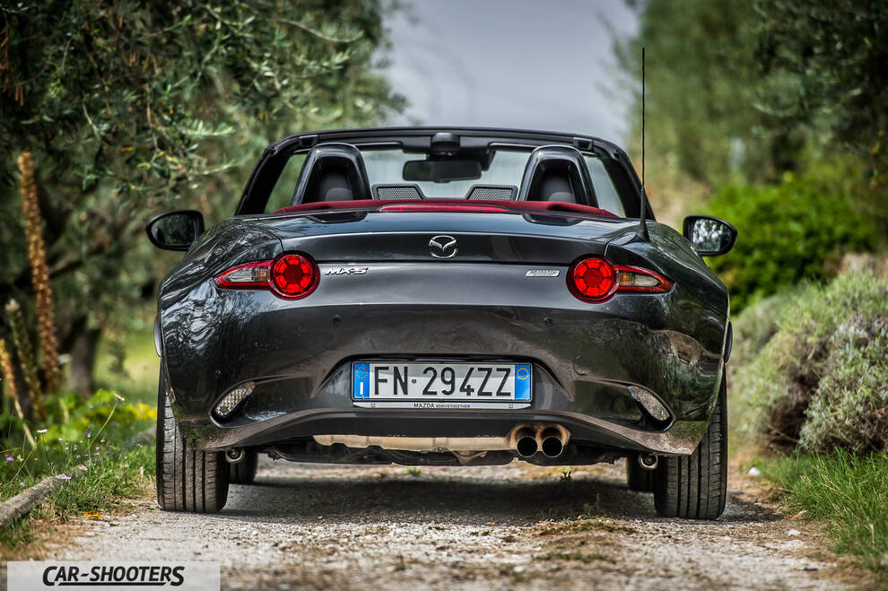 Mazda MX 5 Cherry Edition – rear view, dark grey on a dirt road