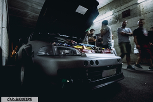 engine bay, in an underground garage with people
