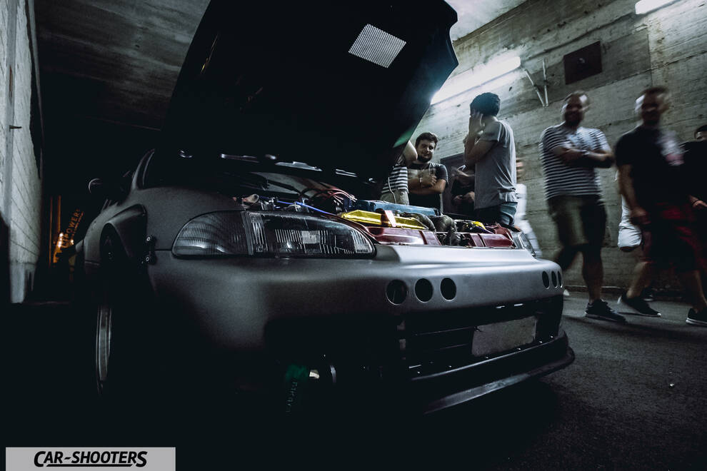 engine bay, in an underground garage with people