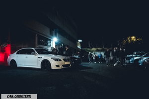 front three-quarter, white in a parking lot at night