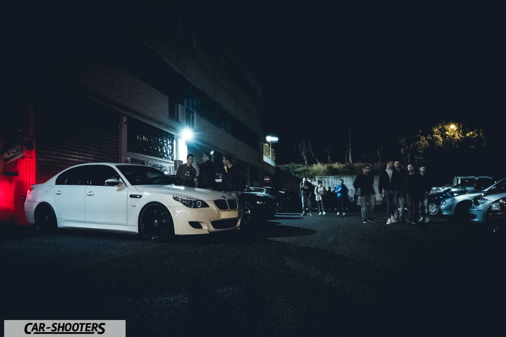 front three-quarter, white in a parking lot at night