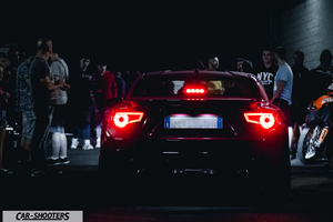 rear view, black surrounded by a crowd at night