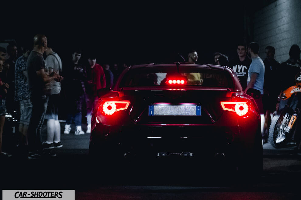 rear view, black surrounded by a crowd at night