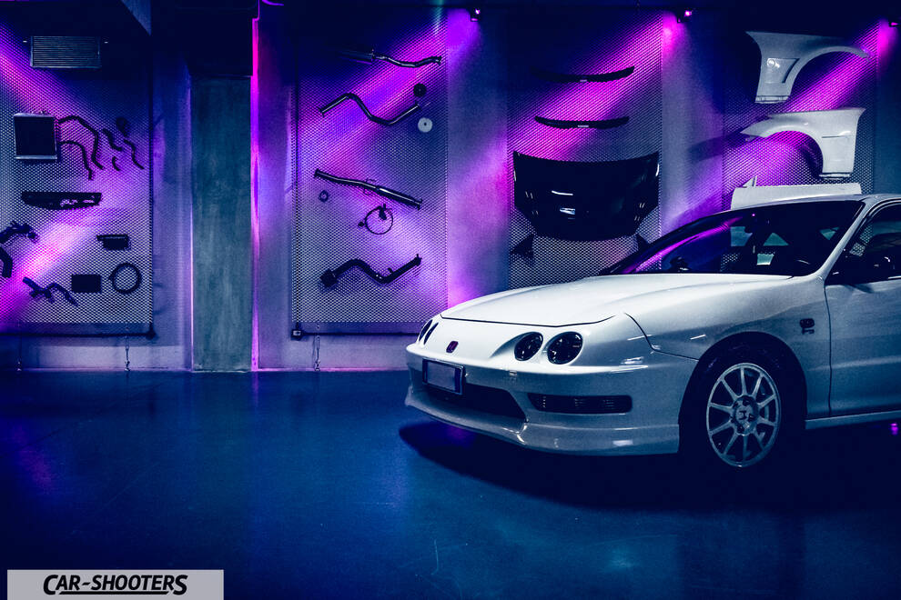 front three-quarter, white in a showroom with parts on wall