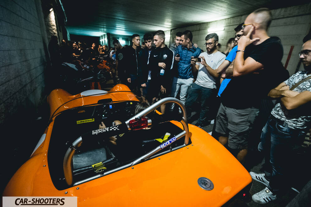 rear three-quarter, orange surrounded by a crowd of people