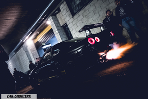 rear three-quarter, black shooting flames from exhaust at night