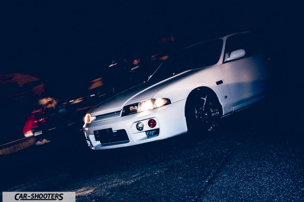 front three-quarter, white parked at night