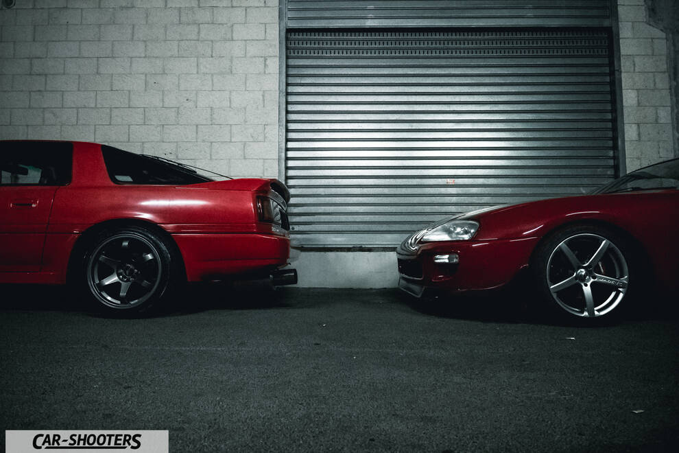 side profile, red in front of a garage door