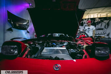 engine bay, in an indoor showroom setting