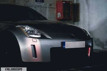 front three-quarter, silver metallic in a parking garage