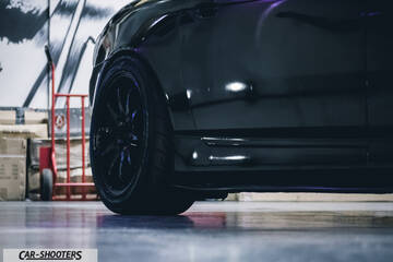 side profile, black in a garage