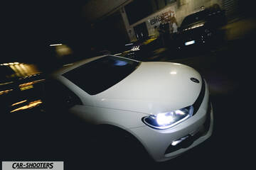 front three-quarter, white at night in a parking lot