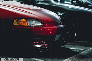 front three-quarter, red in a parking lot