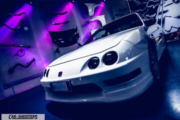 front three-quarter, white in a tuned parts showroom