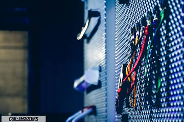detail, perforated metal storage panel with straps