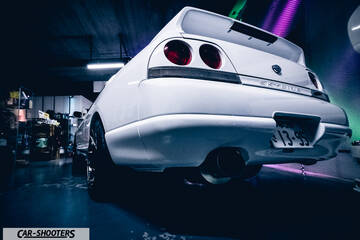 rear three-quarter, white in a dimly lit garage
