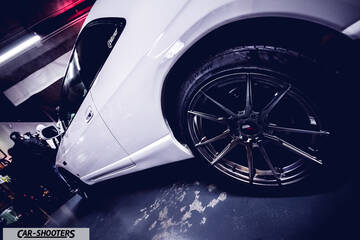 side profile, white in an indoor garage
