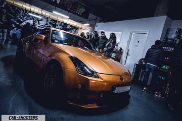 front three-quarter, bronze metallic in an indoor garage