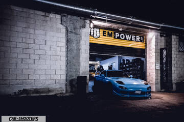 front three-quarter, light blue parked inside a garage