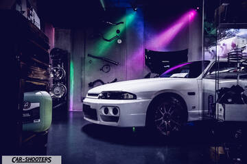 front three-quarter, white in a dimly lit garage