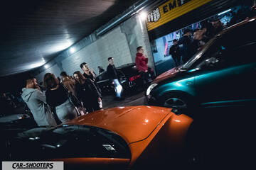 front three-quarter, orange at a night car meet