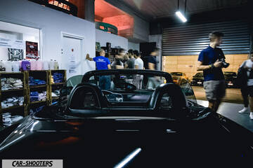 rear view, black in a garage with people