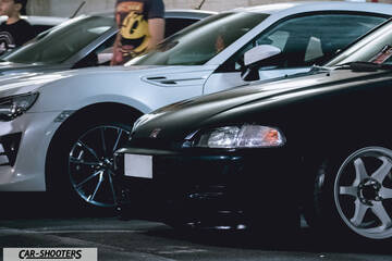front three-quarter, black in a parking lot