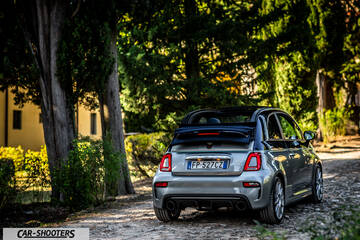 Abarth 695 Rivale – rear three-quarter, silver metallic on a wooded country road