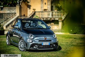 Abarth 695 Rivale – front three-quarter, grey parked on grass in front of a villa
