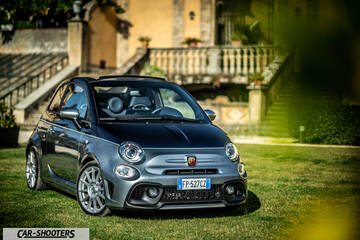 Abarth 695 Rivale – front three-quarter, grey parked on grass in front of a villa