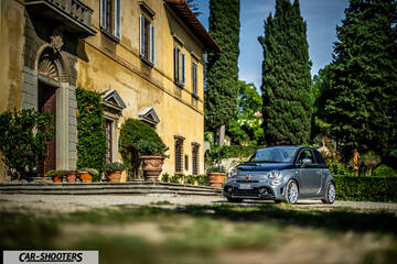 Abarth 695 Rivale – front three-quarter, grey metallic parked beside a historic building