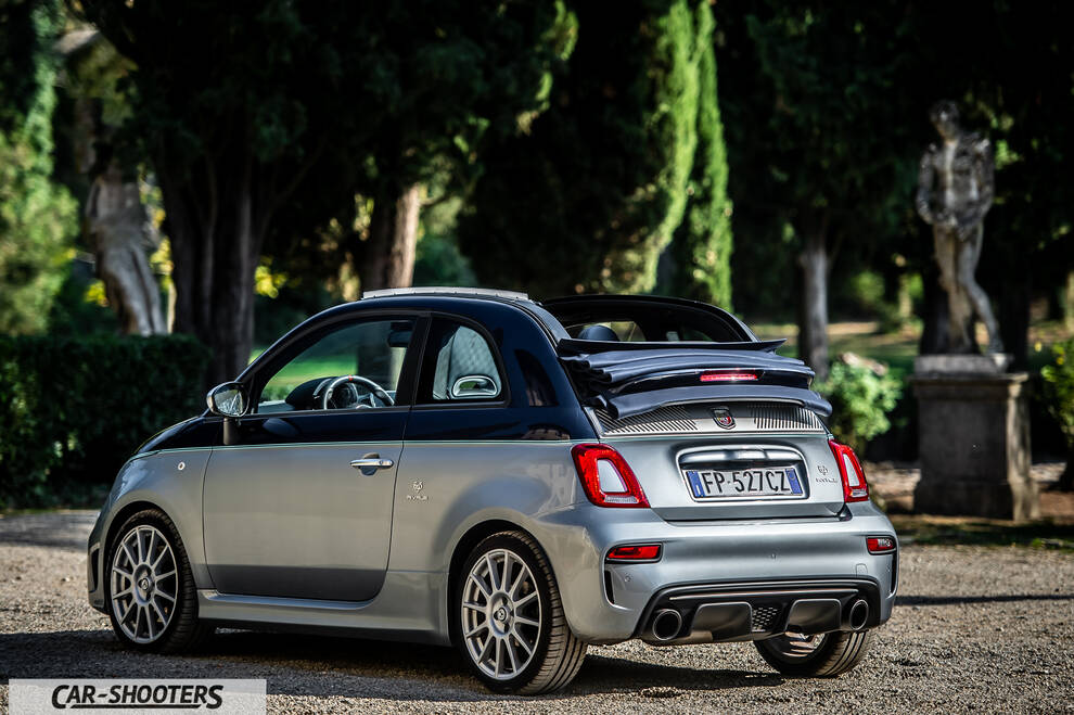Abarth 695 Rivale – rear three-quarter, silver metallic in a lush garden
