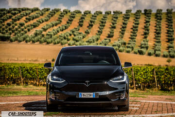 Tesla Model X – front three-quarter, black against a hilly vineyard backdrop