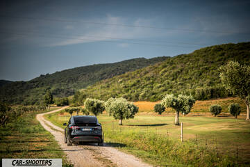 Tesla Model X – rear view, black on a country road