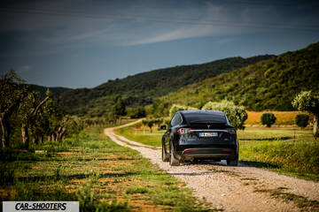 Tesla Model X – rear view, black on a country road