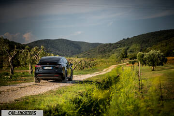 Tesla Model X – rear three-quarter, black on a country road