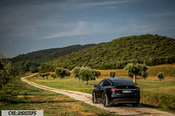 Tesla Model X – rear three-quarter, black on a country road