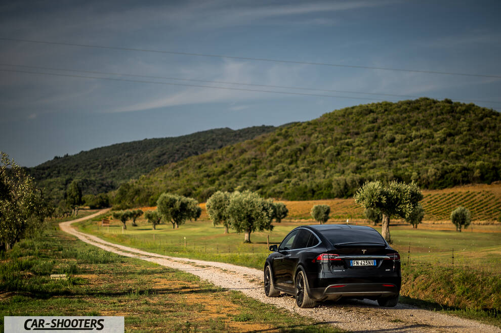 Tesla Model X – rear three-quarter, black on a country road