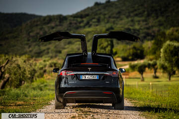 Tesla Model X – rear view, black on a country road