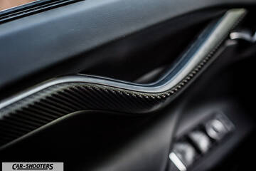 Tesla Model X – interior, carbon fiber door handle close-up