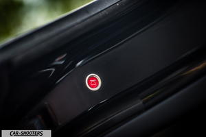 Tesla Model X – detail, red trunk release button close-up