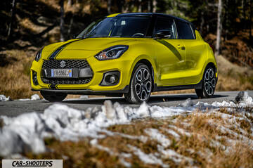 Suzuki Swift Sport – front three-quarter, yellow on a snowy roadside