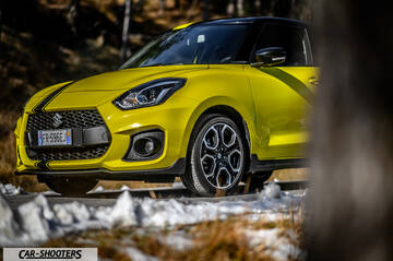 Suzuki Swift Sport – front three-quarter, yellow on a road with snow