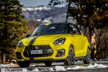 Suzuki Swift Sport – front three-quarter, yellow against a mountain backdrop