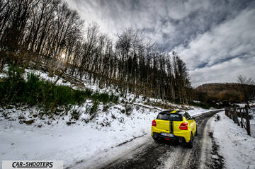 Suzuki Swift Sport – rear three-quarter, yellow on a snowy country road