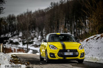 Suzuki Swift Sport – front three-quarter, yellow on a snowy winding road